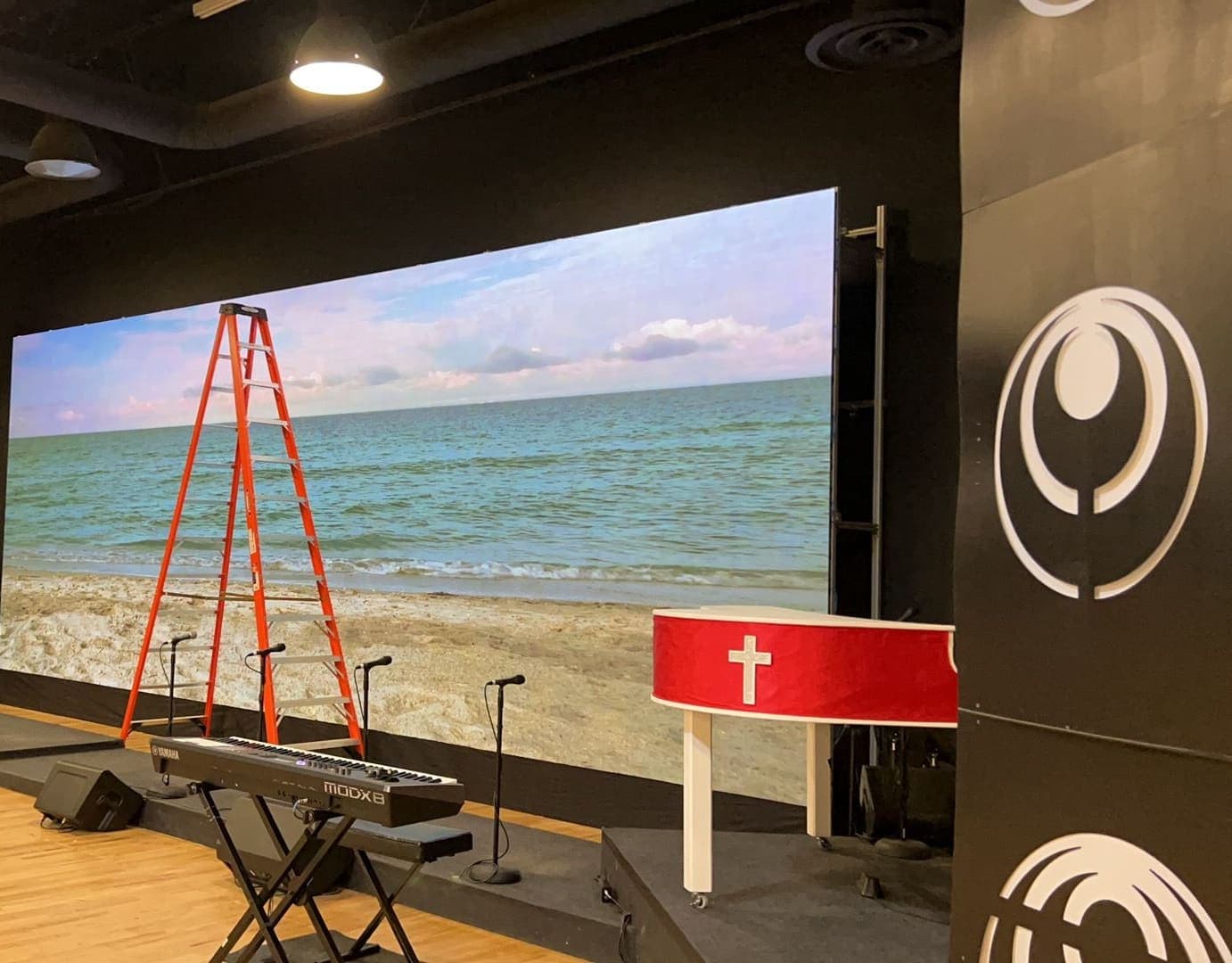 A wall on a black-box stage, hung on its own frame